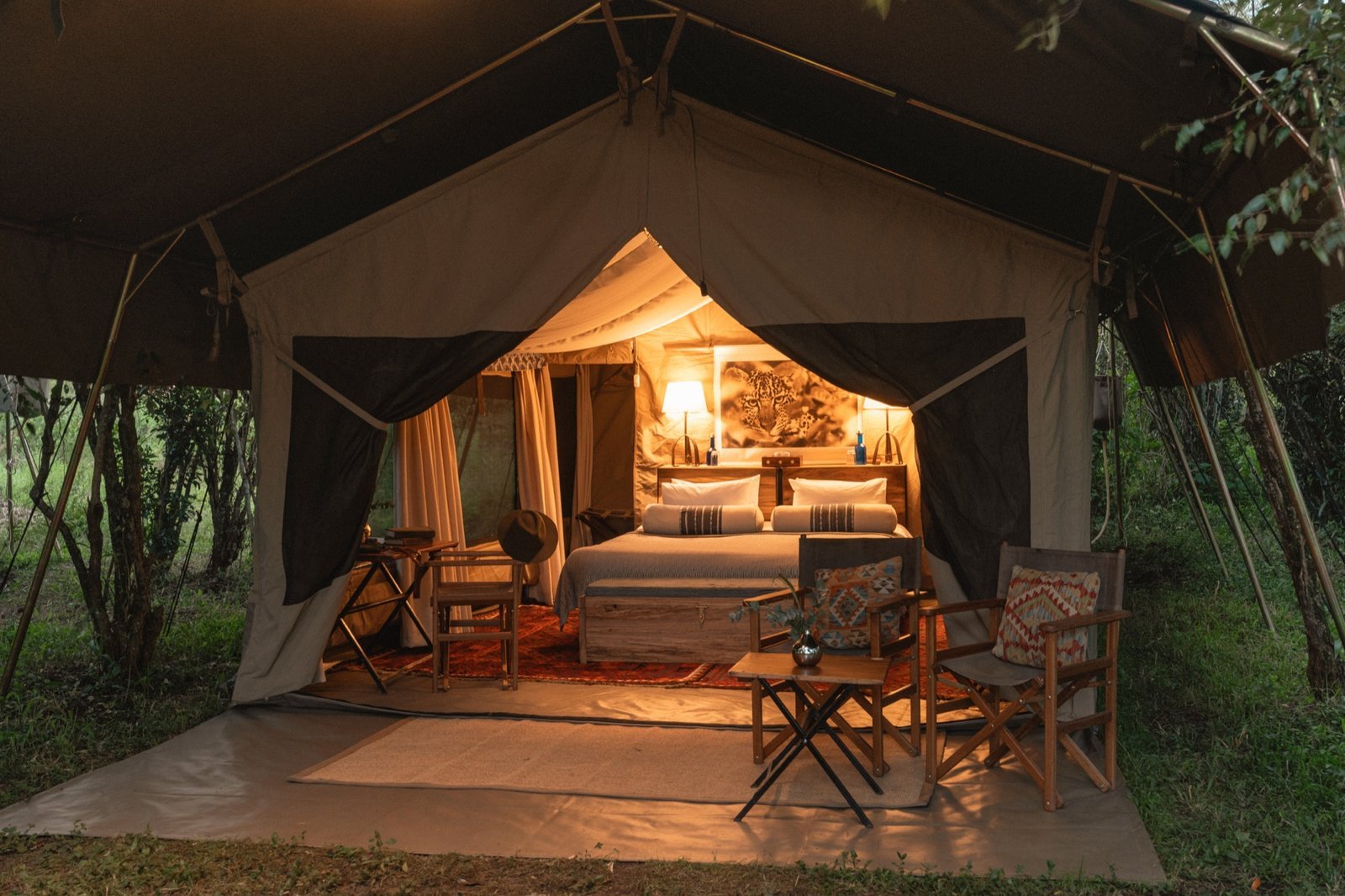A Ker & Downey luxury safari tent glowing at dusk